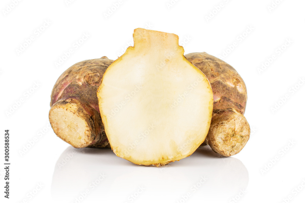 Group of two whole one half of fresh brown jerusalem artichoke isolated on white background