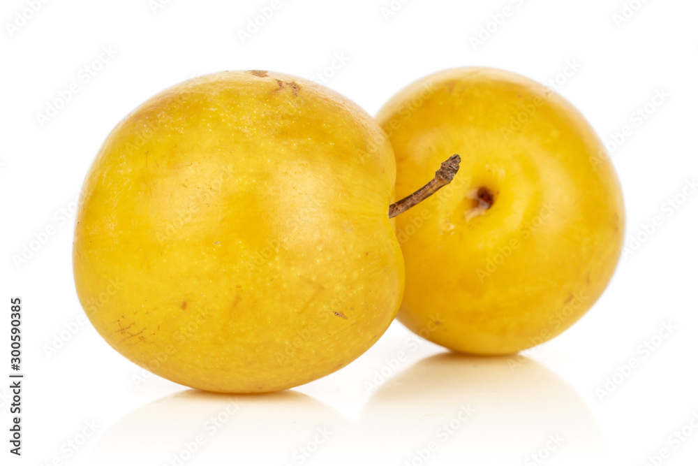 Group of two whole fresh yellow plum isolated on white background