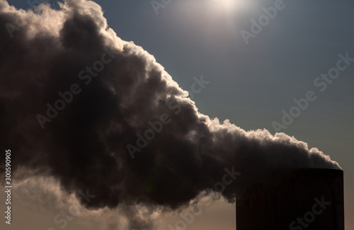 Pollution or Smoke Coming From a Chimney Blocking Out The Sun