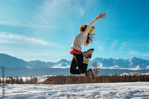 Happy girl jumps with snow winter concept photo