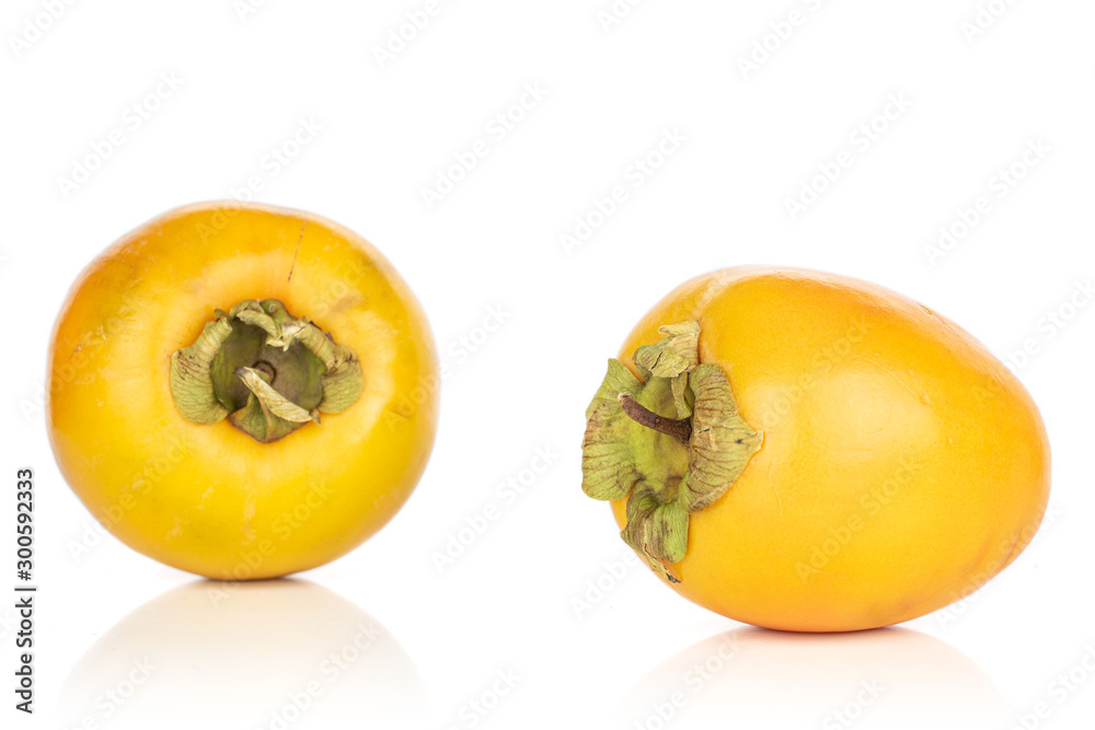 Group of two whole sweet orange persimmon isolated on white background
