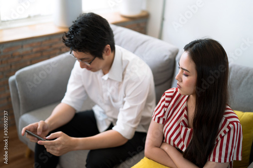 The woman looked at her boyfriend in anger because he kept playing the game until ignored her.