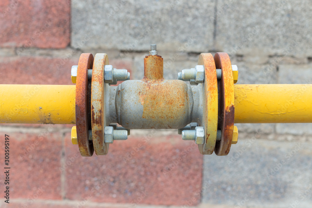 Natural gas valve painted in yellow color, closeup Natural gas valve painted in yellow color, closeup