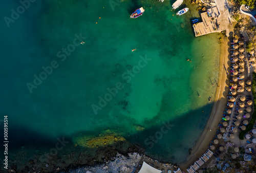 sandy beach with sunbeds and umbrellas, lot of bathing and resting people, view from drone, Greece, Rhodes. Europe © vladimircaribb