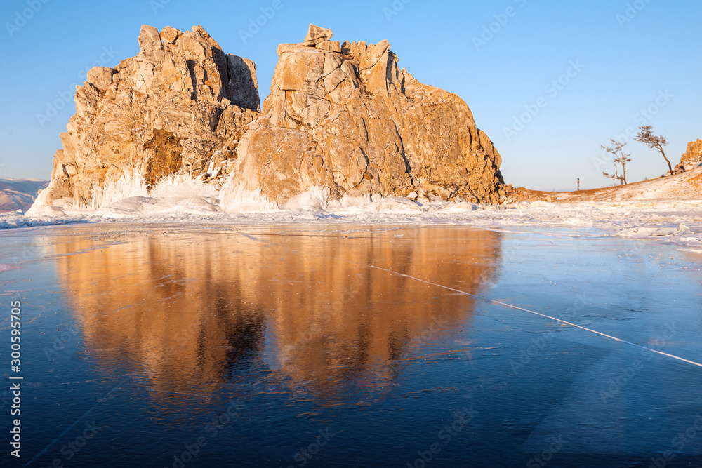 Winter Baikal. Olkhon Island. Reflection on the ice Shamanka rock