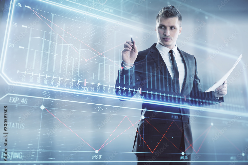 Fototapeta premium Businessman standing with business theme hologram. Multi exposure. Concept of analysis