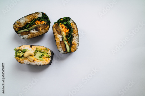 Tofu onigirazu and broccoli onigirazu on white background. Japanese cuisine. Top view. photo