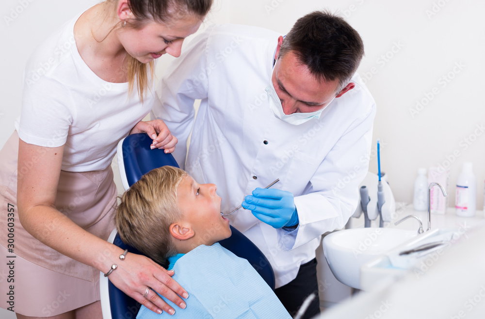 Fototapeta premium Female with son are visiting dentist