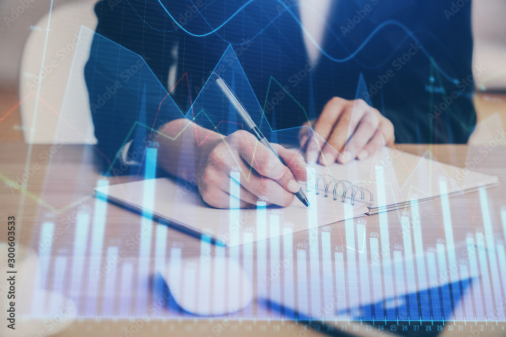 Forex graph on hand taking notes background. Concept of research. Multi exposure Forex graph on hand taking notes background. Concept of research. Multi exposure