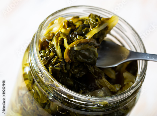 Glass jar with pickled swiss chard