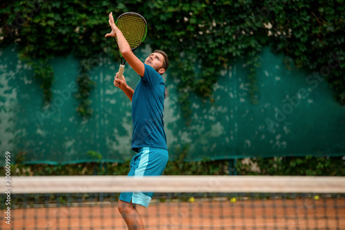Tennis player getting ready to hit a ball and looking up © yuriygolub