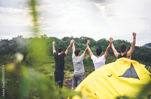 Group of best friends with hands raise up and looking beautiful view feeling happy and smiling together at nature photo