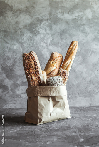 French pastries, baguettes on a gray background in a paper bag.