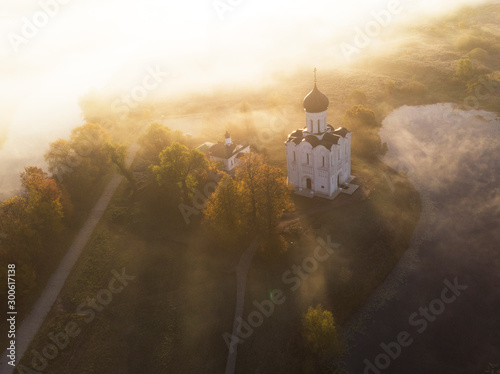 Church of Intercession upon Nerl River. (Bogolubovo, Vladimir region, Golden Ring of Russia) in autumn morning. Aerial photo photo