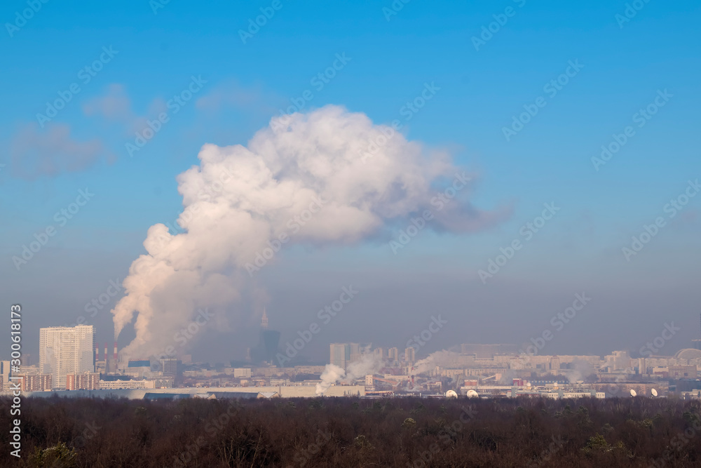 Panorama of the city, smog and smoke over the city in clear winter weather.