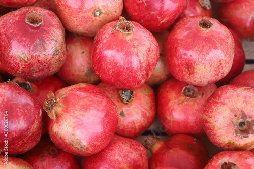 closeup of red pomegranates on display at the market