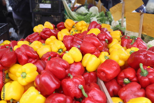 Fototapeta Naklejka Na Ścianę i Meble -  closeup of yellow and red peppers on display at the market
