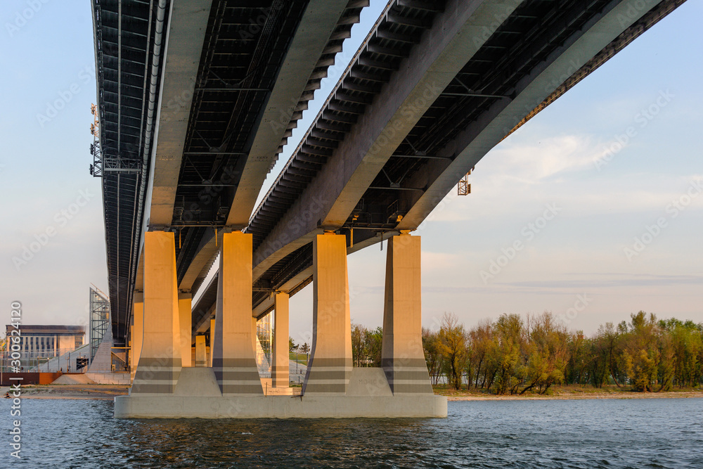 New concrete bridge over the river, autumn, sunset, evening. Close-up.