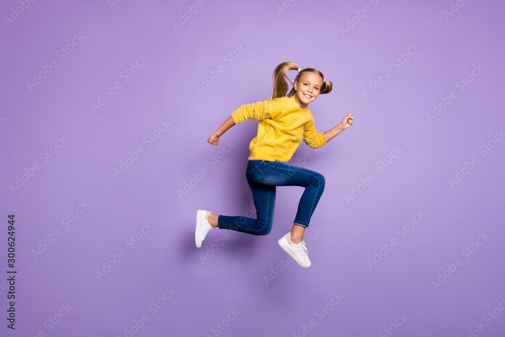 Full body photo of cheerful sweet kid jump run after black friday bargains wear casual style clothing isolated over purple color background