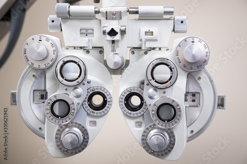 close up on eyesight testing equipment in an Optometrists office, optical phoropter background photo