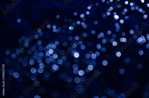 Abstract pattern of blue bokeh garland lights on a dark background