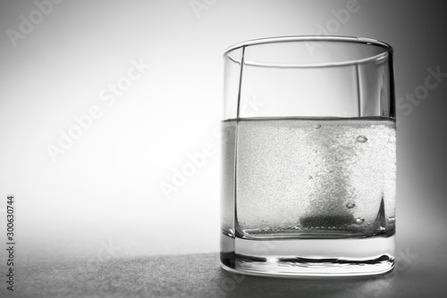 tablet dropped into the water on white background