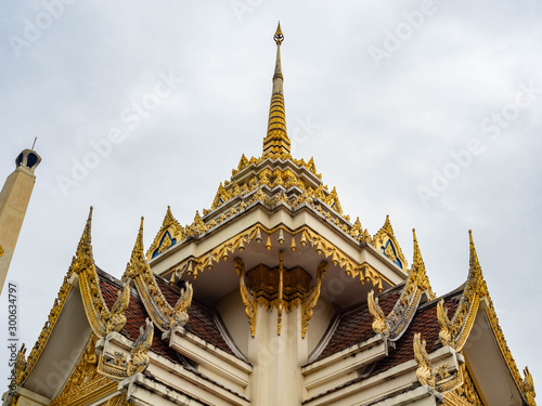 Crematory architecture style Thai with details texture is beautiful golden in temple name is Wat kaew at Bangkok Thailand,In date sky cloudy © K illustrator Photo