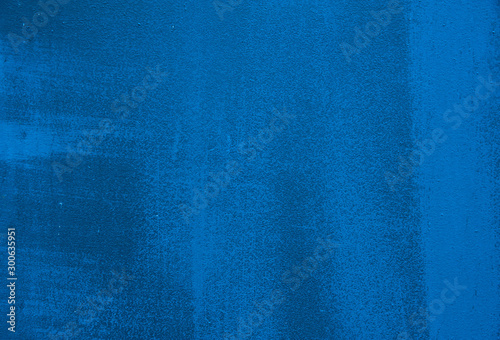 Abstract background. Streaks and scratches on the bright blue painted metal surface. Background, structure.
