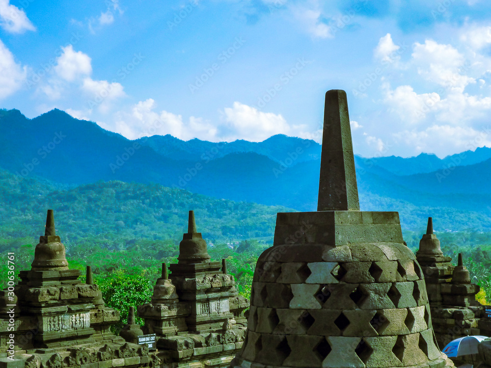 Stupas of old temple complex surrounded by mountains under beautiful blu sky