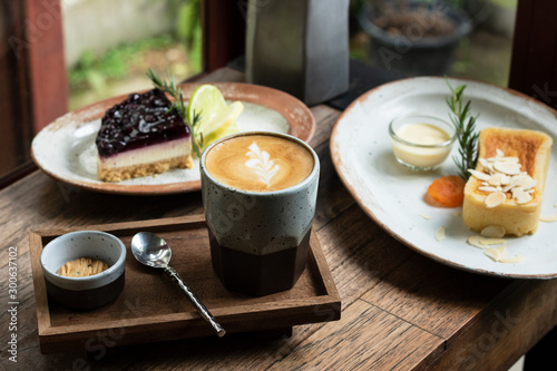 latte coffee in acup and dessert cake on table photo