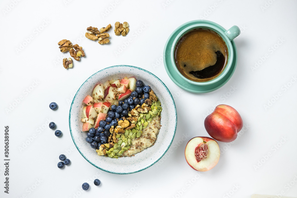 oatmeal breakfast with blueberries and peach and a cup of coffee