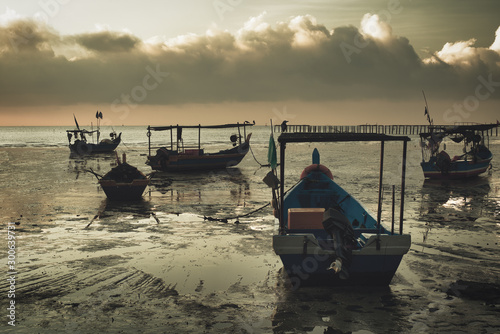 Photography haphazard moored boats at low tide