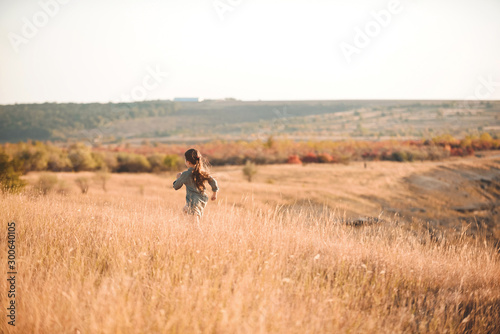 running girl in autumn field