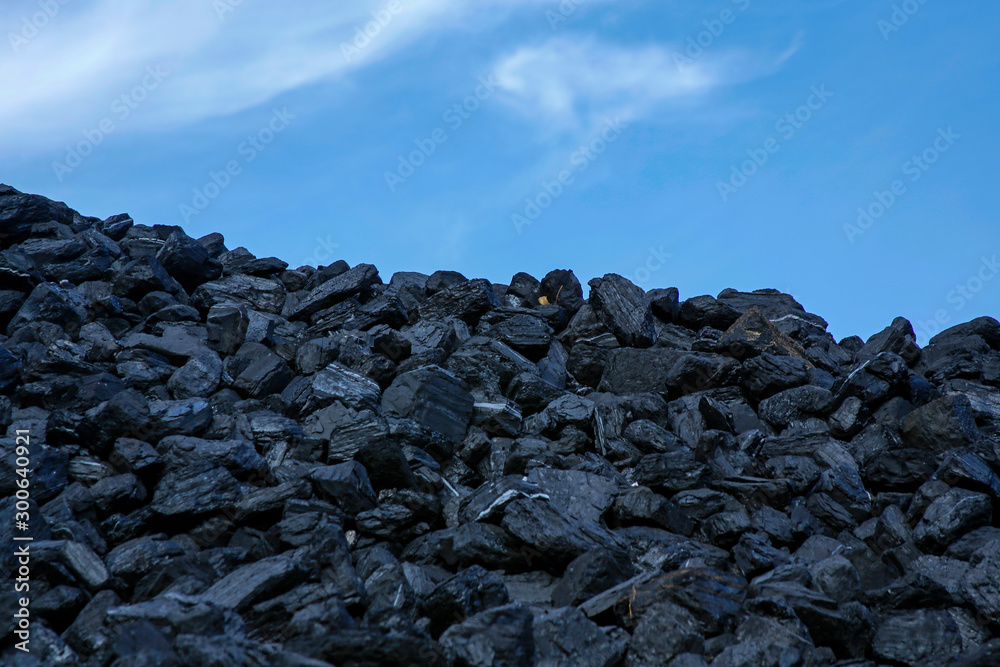heap of coal against blue sky
