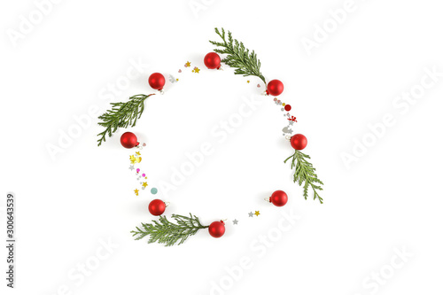 Minimalist composition on a white background. Christmas decorations, place for your product. Flat lay, Copy spay, Winter time. December background of winter. Fir branches.