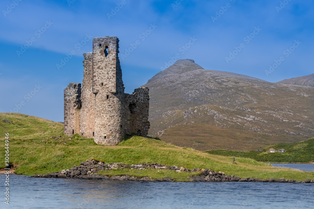 Mesmerizing ruins of Ardvreck Castle standing on a rocky promontory jutting out into Loch Assynt in Sutherland, Highlands of Scotland.