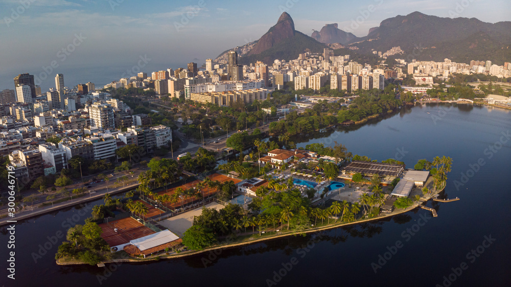 Aerial panorama of the city lake of Rio de Janeiro with exclusive club Caiçaras on the island in Ipanema in the foreground and neighbourhood of Leblon and Two Brothers mountain in the background