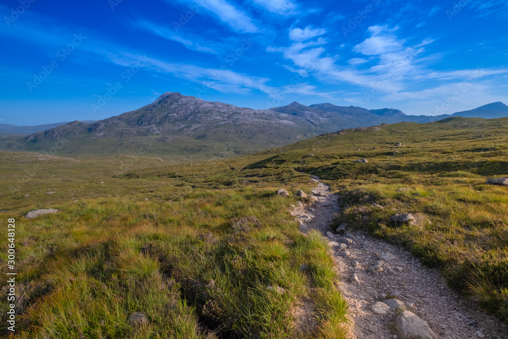 Hiking the Torridon Hills, made of some of the oldest rocks in the world and among the most spectacular peaks in the British Isles. Highlands of Scotland.