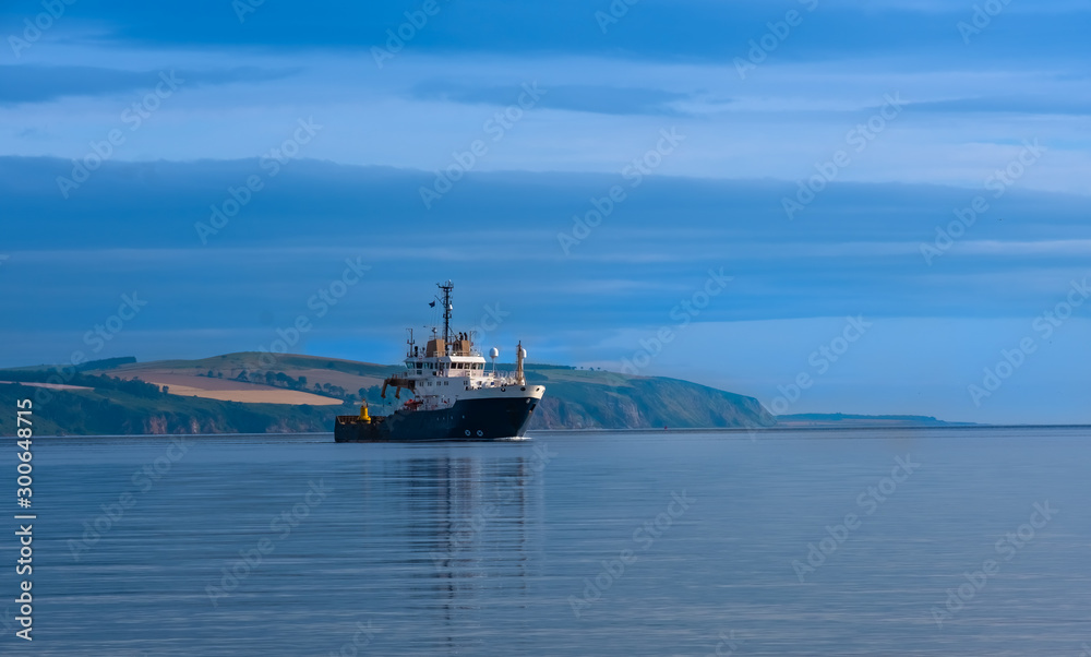 A ship approches Chanonry Point at the end of Chanonry Ness, Moray Firth, Black Isle, Scotland.