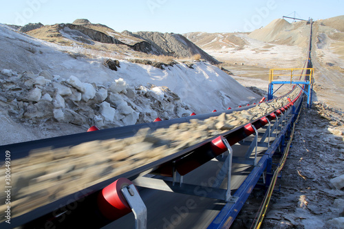 Industrial conveyor belt moves ore from a quarry photo