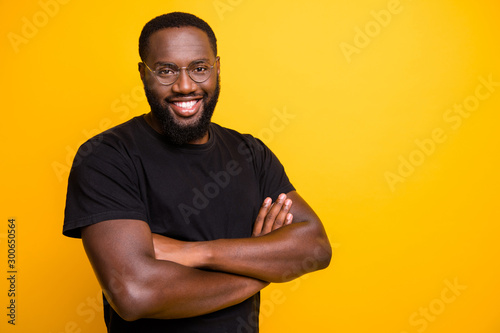 Photo of cheerful positive handsome attractive man smiling toothily t-shirt with hands folded isolated vivid color background