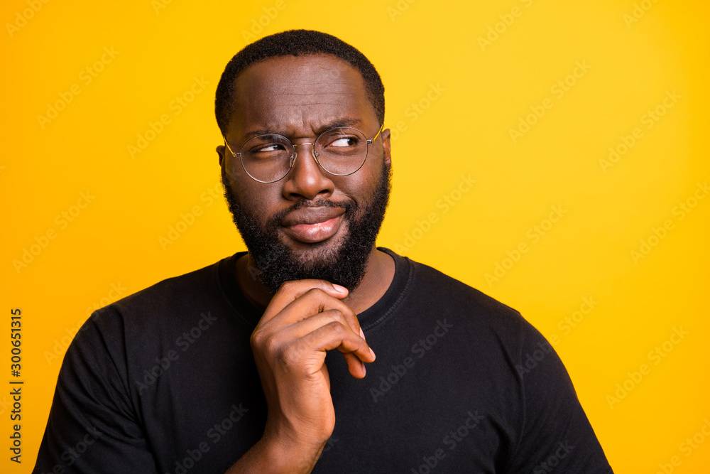 Photo of pensive interested planning contemplating choosing man making choice in eyewear t-shirt isolated vivid color backgroudn Photo of pensive interested planning contemplating choosing man making choice in eyewear t-shirt isolated vivid color backgroudn