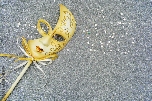 Beautiful Christmas card. Masquerade mask with bows on a silver 
