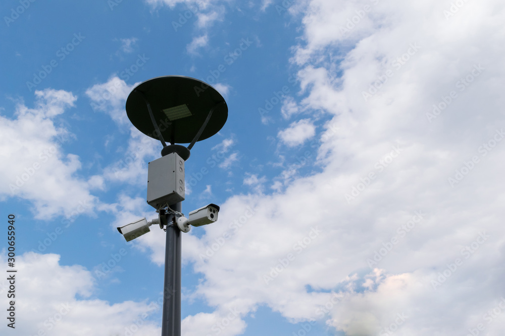 security surveillance cameras mounted on street light pole with copy space