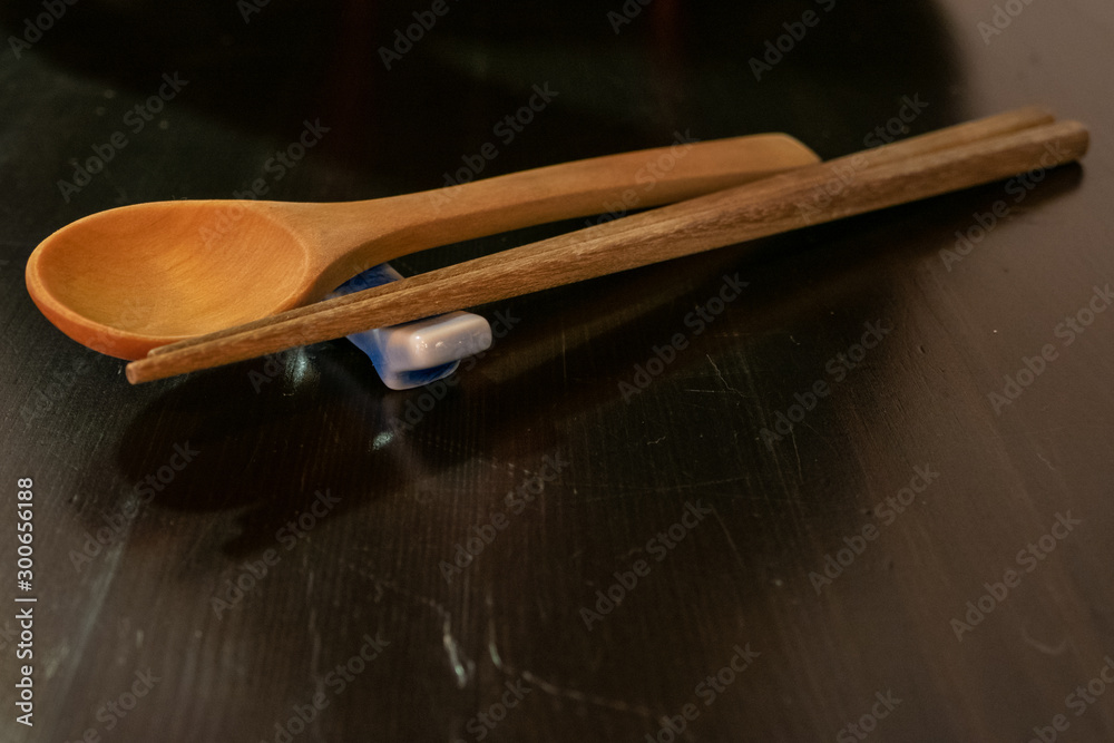 wooden spoon and chopsticks on wood table wooden spoon and chopsticks on wood table