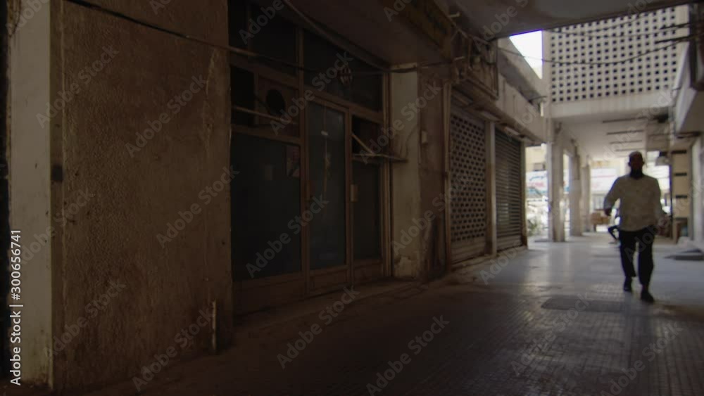 Man walking across old building in Dubai Man walking across old building in Dubai
