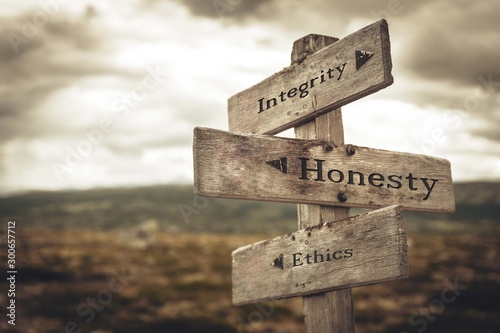 Integrity, honesty and ethics signpost in nature. Message, quotes, words, meaning, goals, company, business, rules, path concept. photo