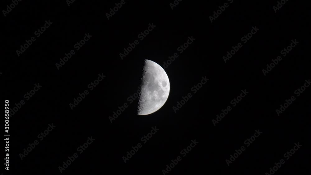 Half of the luminous moon passes through the night sky. Time lapse Half of the luminous moon passes through the night sky. Time lapse