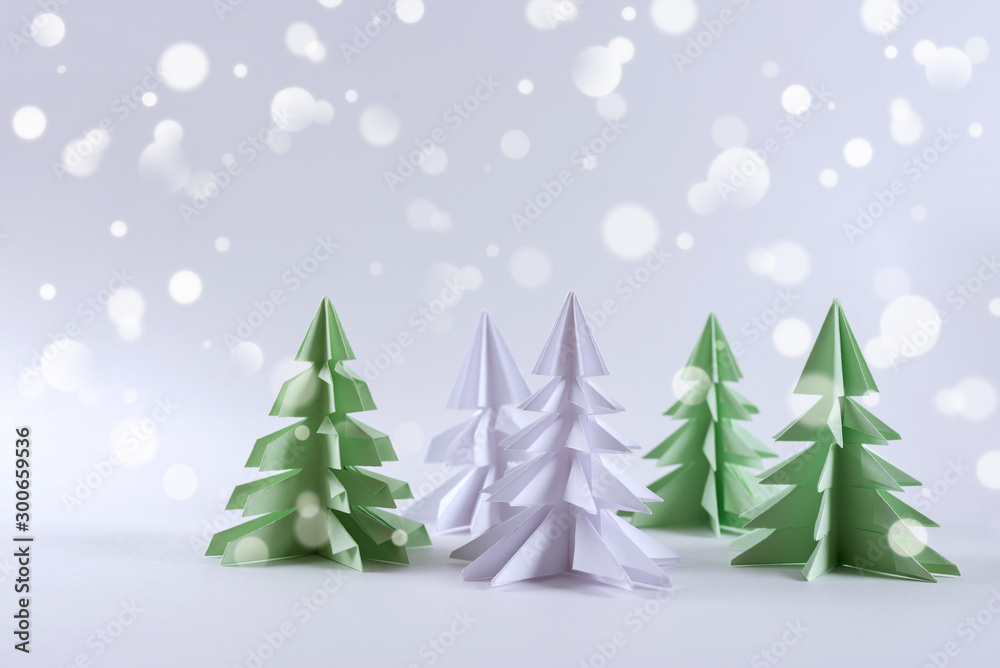 Christmas concept. Origami paper green Christmas trees.