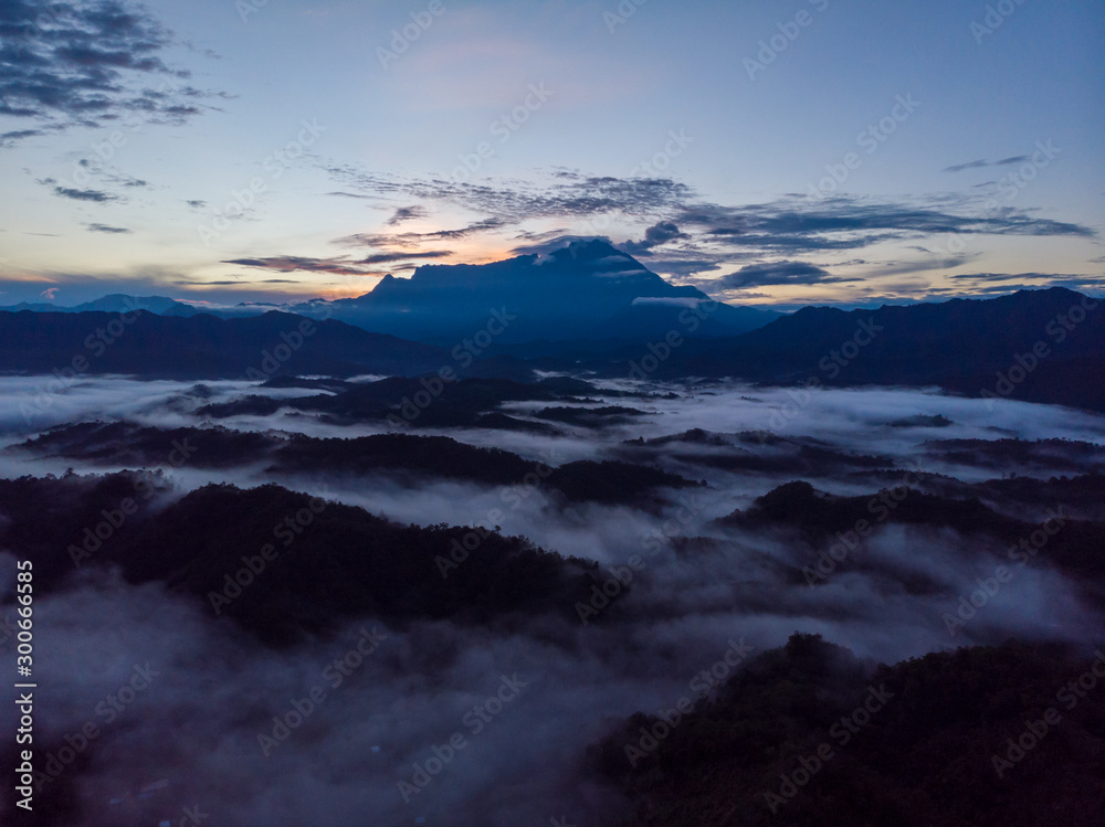 Rural landscape with dramatic sea of cloud during sunrise with Mount Kinabalu at Saba, Borneo